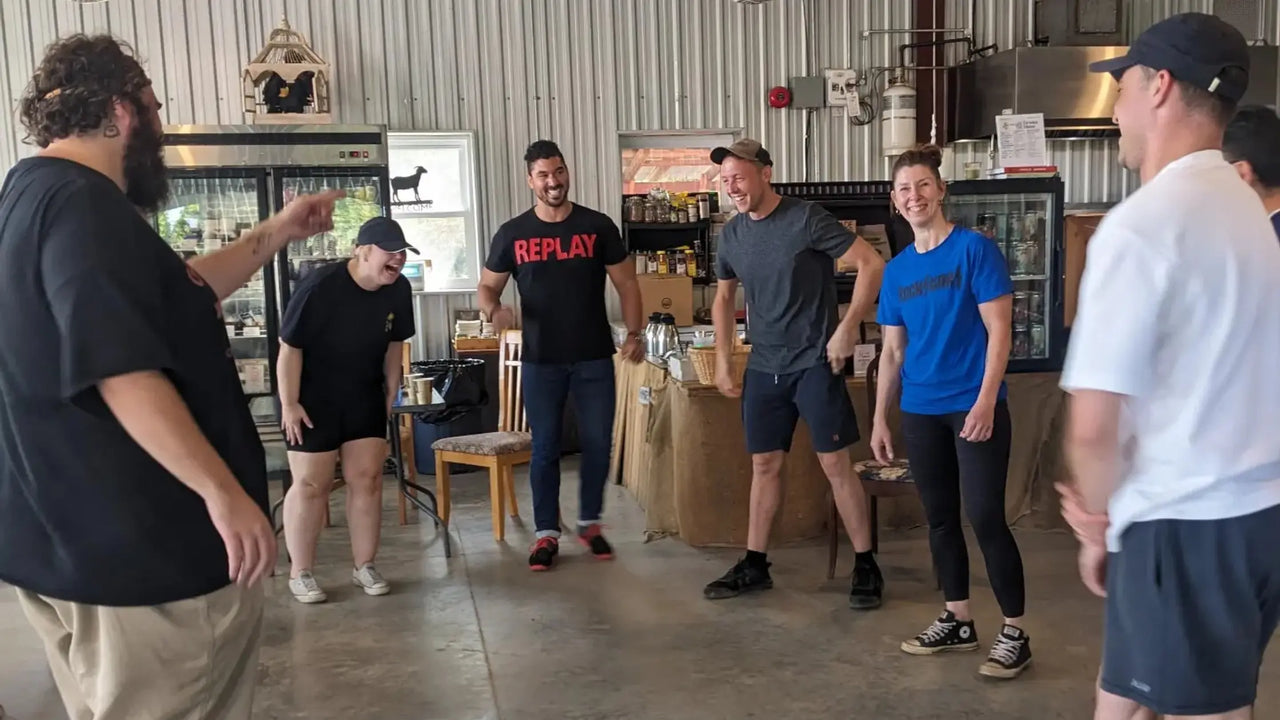 Team building participants laughing at a comedy workshop